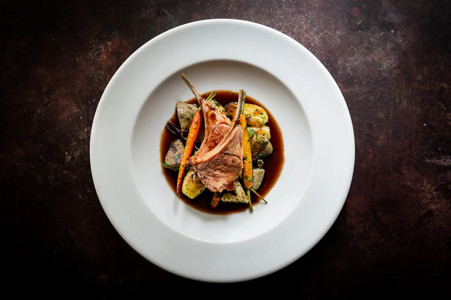 ROAST-RACK-OF-LAMB-WITH-ANCHOVIES-SEASONAL-VEGETABLES FINE & WILD